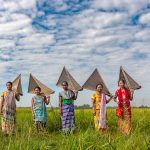 Tribal using bamboo nets to catch fish and snails after paddy cultivation